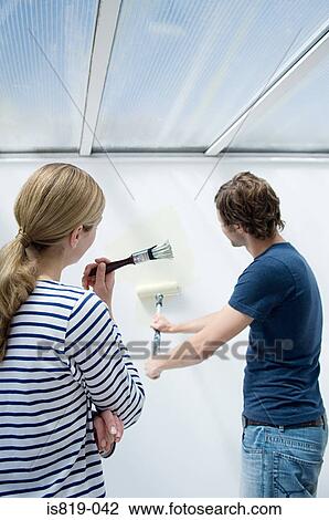 Couple painting wall View Large Photo Image Stock Image - Couple painting wall. Fotosearch
