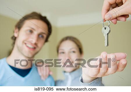 Stock Photography - Couple taking keys. Fotosearch