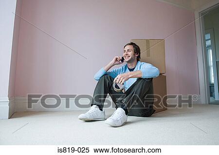 Man on mobile by cardboard boxes View Large Photo Image Stock Photography - Man on mobile by cardboard boxes. Fotosearch