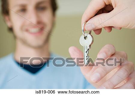 Stock Photograph - Man taking keys. Fotosearch
