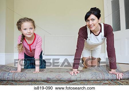 Mother and daughter rolling rug View Large Photo Image Stock Image - Mother and daughter rolling rug. Fotosearch