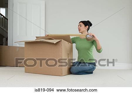 Woman packing up boxes View Large Photo Image Picture - Woman packing up boxes. Fotosearch