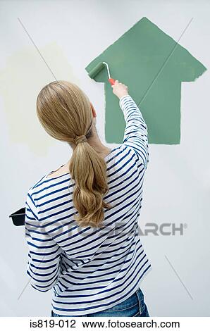 Woman painting a house on the wall View Large Photo Image Stock Image - Woman painting a house on the wall. Fotosearch