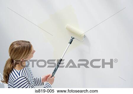 Woman painting a wall View Large Photo Image Stock Photography - Woman painting a wall. Fotosearch