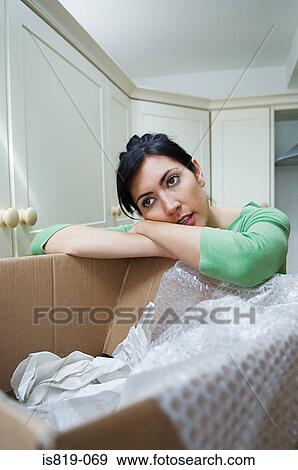 Woman tired of unpacking View Large Photo Image Stock Photo - Woman tired of unpacking . Fotosearch