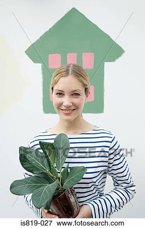 Woman with houseplant View Large Photo Image Stock Photo - Woman with houseplant. Fotosearch