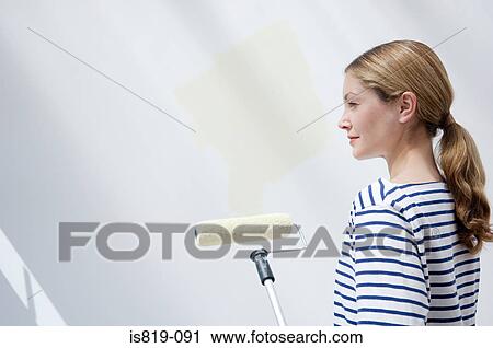 Woman with paint roller View Large Photo Image Stock Image - Woman with paint roller. Fotosearch