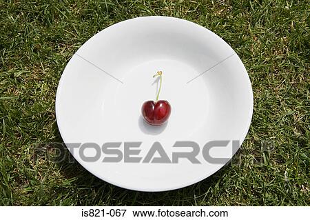 Stock Photo - A cherry on a plate. Fotosearch