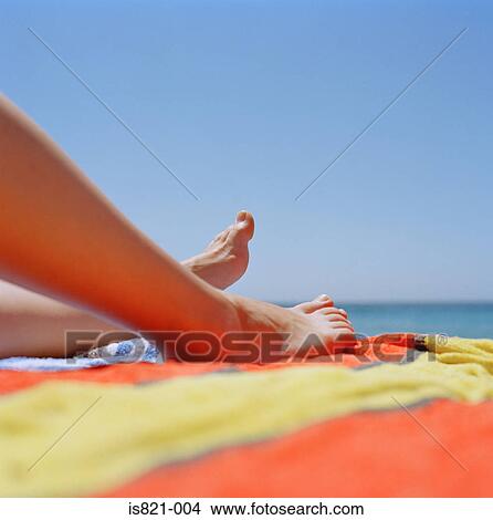 Legs of woman sunbathing View Large Photo Image Picture - Legs of woman sunbathing. Fotosearch