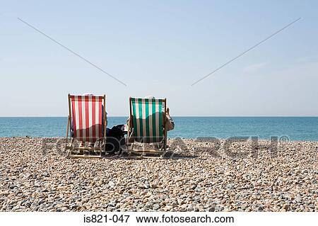People in deckchairs at the beach View Large Photo Image Stock Photo - People in deckchairs at the beach. Fotosearch