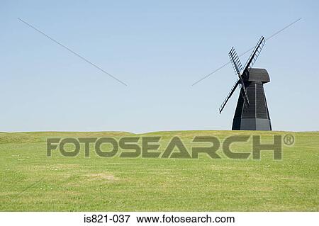 Windmill in a field View Large Photo Image Stock Photo - Windmill in a field. Fotosearch