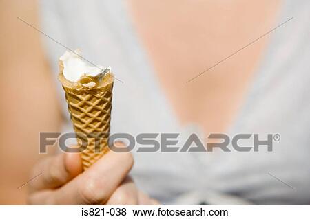 Woman holding an ice cream cone View Large Photo Image Stock Photo - Woman holding an ice cream cone. Fotosearch