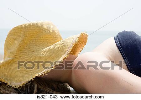 Woman with a straw hat over her face View Large Photo Image Stock Image - Woman with a straw hat over her face. Fotosearch