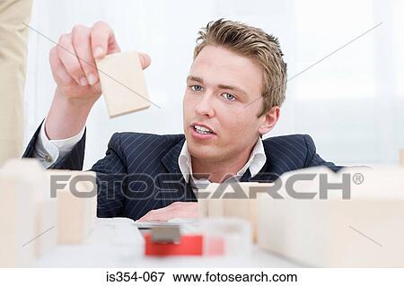 Architect arranging fashion model View Large Photo Image Stock Photo - Architect arranging fashion model. Fotosearch