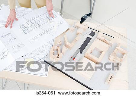 Architect with fashion model and plans View Large Photo Image Stock Image - Architect with fashion model and plans. Fotosearch