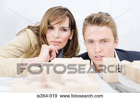 Architects looking at fashion model View Large Photo Image Stock Photo - Architects looking at fashion model. Fotosearch