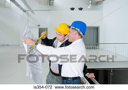 Architects looking at plans View Large Photo Image Stock Image - Architects looking at plans. Fotosearch