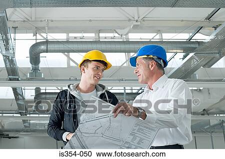 Stock Image - Architects with plans. Fotosearch