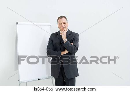 Businessman and flipchart View Large Photo Image Stock Photography - Businessman and flipchart. Fotosearch
