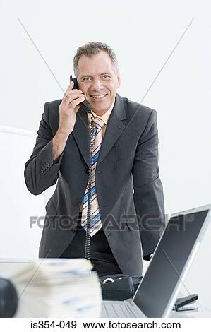 Stock Photo - Businessman at his desk. Fotosearch