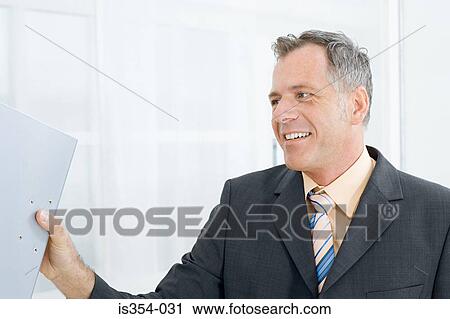 Businessman with ring binder View Large Photo Image Stock Image - Businessman with ring binder. Fotosearch