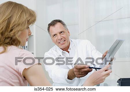 Doctor and patient looking at scan View Large Photo Image Stock Photography - Doctor and patient looking at scan. Fotosearch