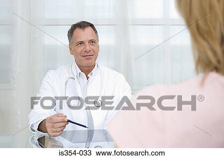 Stock Image - Doctor giving consultation. Fotosearch