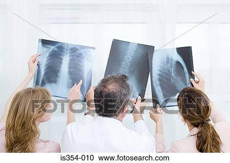 Stock Image - Doctors looking at x-rays. Fotosearch