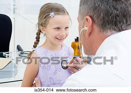 Girl being checked by a doctor View Large Photo Image Picture - Girl being checked by a doctor. Fotosearch