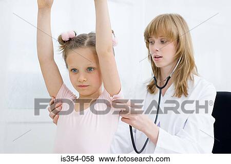 Girl having a check up with doctor View Large Photo Image Stock Photo - Girl having a check up with doctor. Fotosearch