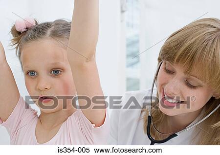 Stock Photography - Girl having a check up with doctor. Fotosearch