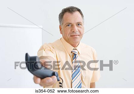 Office worker passing telephone View Large Photo Image Stock Image - Office worker passing telephone. Fotosearch