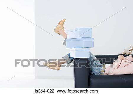 Woman on sofa with shoe boxes View Large Photo Image Stock Image - Woman on sofa with shoe boxes. Fotosearch
