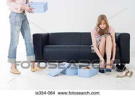 Picture - Woman trying on shoes. Fotosearch
