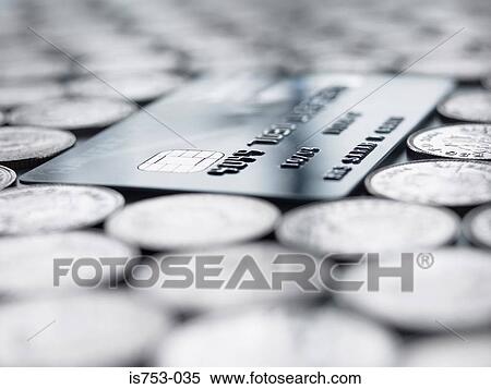 Credit card amongst coins View Large Photo Image Stock Photography - Credit card amongst coins. Fotosearch