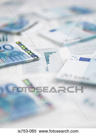 Stock Photography - Pile of twenty euro notes on paperwork. Fotosearch