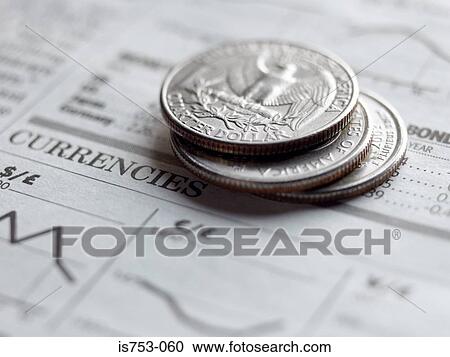 Stock Image - Quarters on a newspaper. Fotosearch