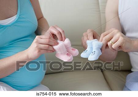 Couple holding baby booties View Large Photo Image Stock Photography - Couple holding baby booties. Fotosearch