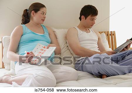Couple sat in bed View Large Photo Image Stock Photo - Couple sat in bed. Fotosearch