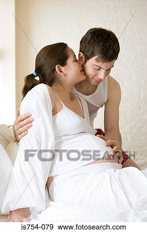 Man touching pregnant partners stomach View Large Photo Image Stock Photo - Man touching pregnant partners stomach. Fotosearch