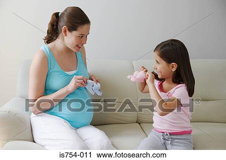 Mother and daughter holding baby booties View Large Photo Image Stock Image - Mother and daughter holding baby booties. Fotosearch