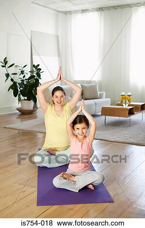 Mother and daughter practising yoga View Large Photo Image Stock Photo - Mother and daughter practising yoga. Fotosearch