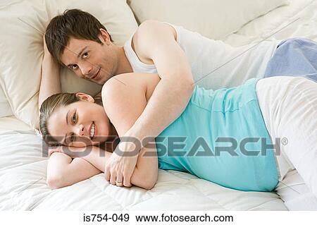 Pregnant woman and partner hugging View Large Photo Image Stock Photo - Pregnant woman and partner hugging. Fotosearch