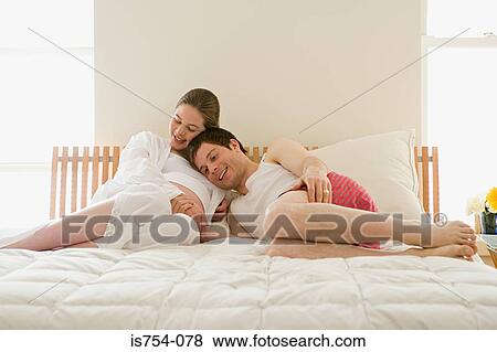 Pregnant woman and partner hugging View Large Photo Image Stock Photo - Pregnant woman and partner hugging. Fotosearch