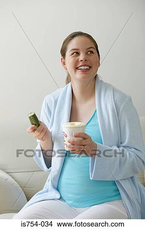 Pregnant woman eating cucumber and ice cream View Large Photo Image Picture - Pregnant woman eating cucumber and ice cream. Fotosearch