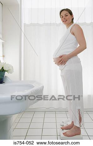 Pregnant woman on scales View Large Photo Image Stock Image - Pregnant woman on scales. Fotosearch