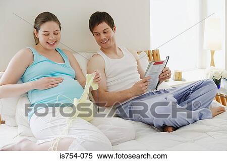 Pregnant woman sat with partner knitting View Large Photo Image Stock Photography - Pregnant woman sat with partner knitting. Fotosearch