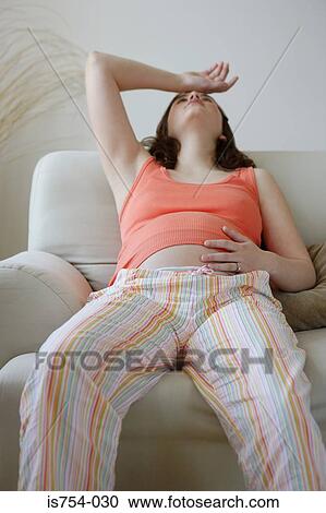 Stock Image - Pregnant woman with hand on head. Fotosearch