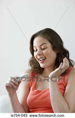 Woman looking at pregnancy test View Large Photo Image Stock Image - Woman looking at pregnancy test. Fotosearch