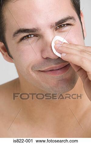 Stock Image - Man cleaning his face. Fotosearch